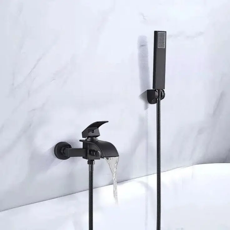Wall-mounted black tap and hand shower against a light stone-patterned wall